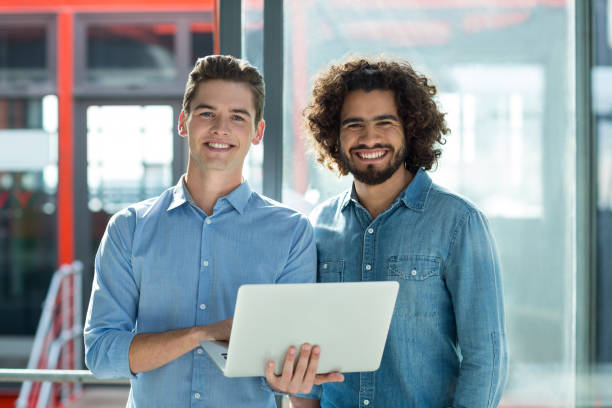 istock Portrait of business executives using laptop in office 660681786