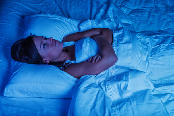 Young Woman in Bed with Insomnia stock photo