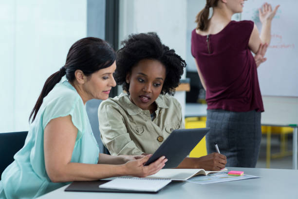 istock Business executives discussing over digital tablet in meeting 660682266