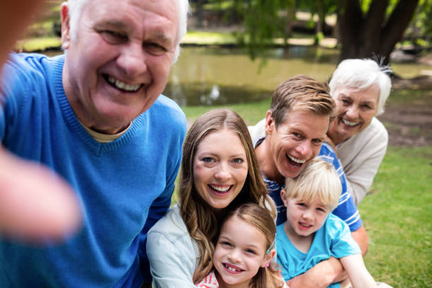 istock Multi-generation family posing for a selfie in the park 660684450