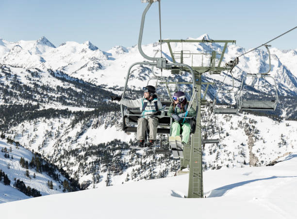 istock Man and woman on ski lift 660685354