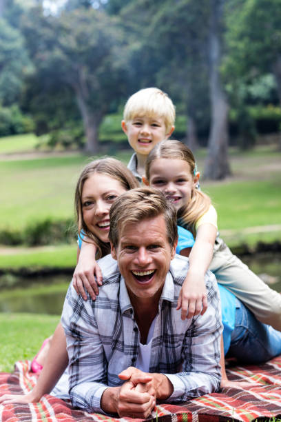 istock Happy family lying in the park 660688702