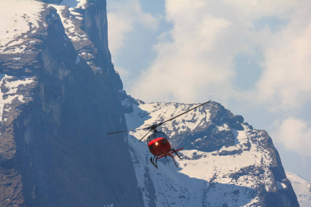 istock Red helicopter and Himalaya Annapurna mountain, Nepal 660689756