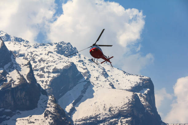 istock Red helicopter and Himalaya Annapurna mountain, Nepal 660690384