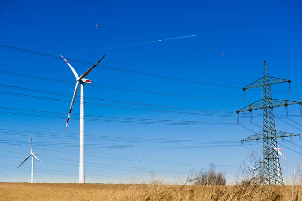 istock Wind turbine and electricity pylon blue sky 660697102