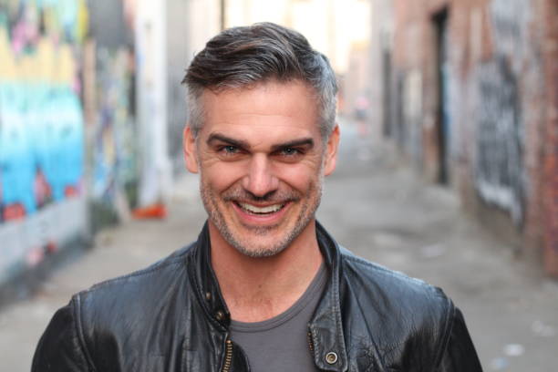 Attractive man with a very cynical smile stock photo