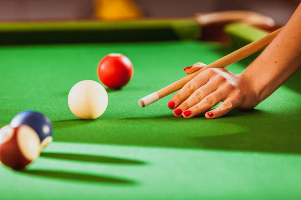 istock Young woman playing billiard. 660697850