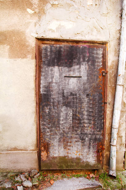 istock Old rusted iron door, rustic architecture exterior of the building 660700252