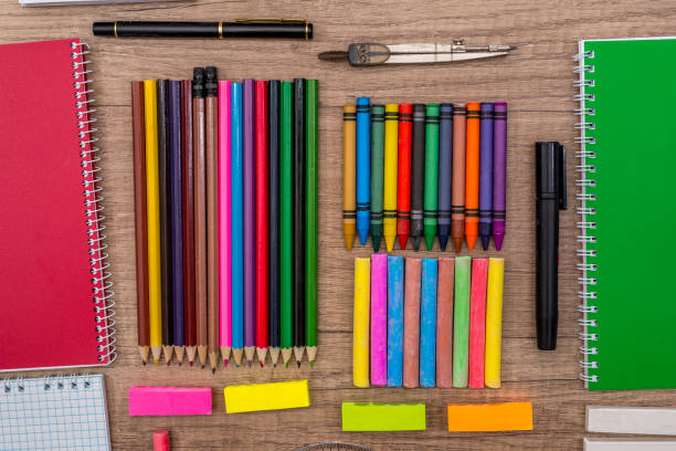 istock School Supplies - colored chalks and  pencils on a wooden background. 660701070