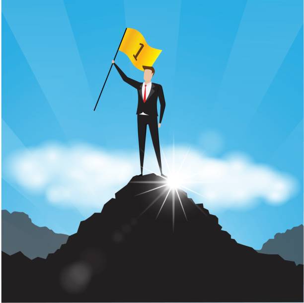 istock Businessman holds a golden flag on top of a mountain 660703284