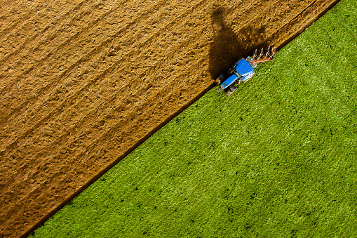 Aerial view of tractor ploughing field