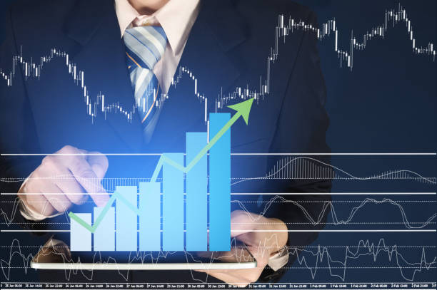 istock Double exposure of businessman using tablet with financial graph chart 660719088
