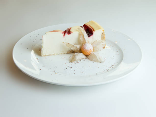 istock Cheesecake with strawberry jam topping isolated on white background 660723394