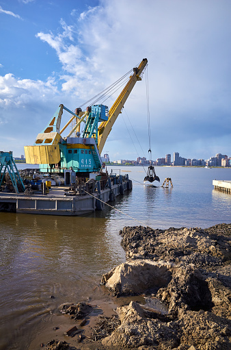Industrial barge dredging crane work coast. Equipment engineering, reflection in water