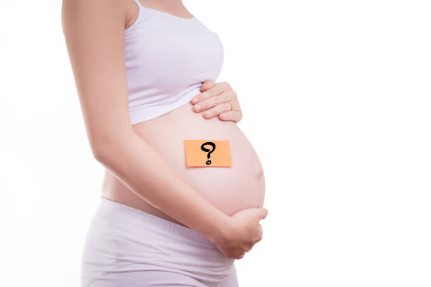istock Pregnant woman with stick notes on her belly, anonymous face 660734396