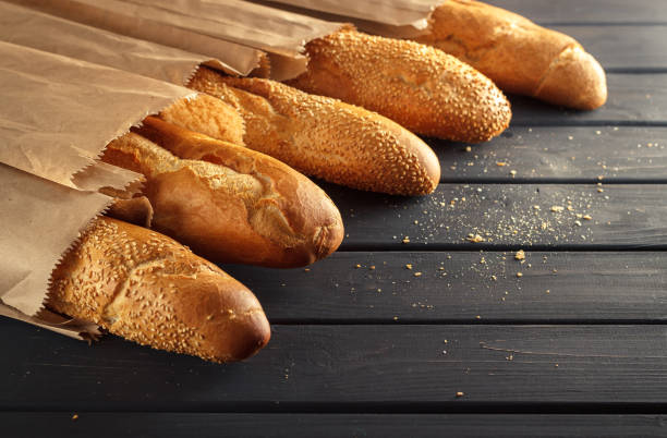 istock French baguettes with sesame seed on black wooden background 660734488