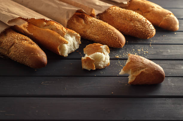 istock French baguettes with sesame seed on black wooden background 660734880