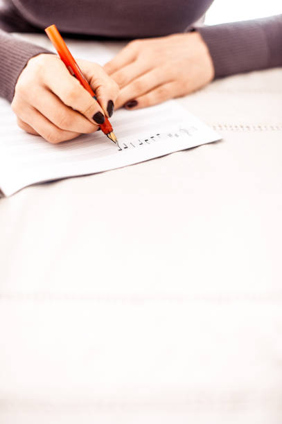 MUSIC COMPOSER WRITING NOTES WITH PENCIL ON THE STAVE. CLOSE UP. COPY SPACE.