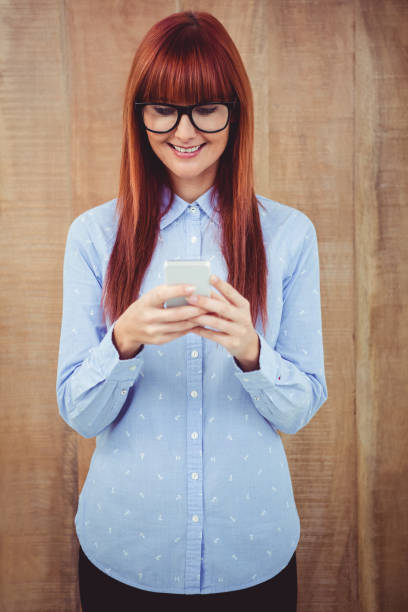 istock Smiling hipster woman texting on her smartphone 660739828