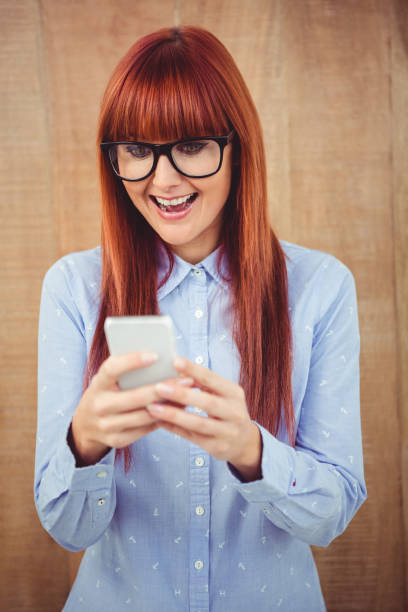 istock Smiling hipster woman texting on her smartphone 660740394
