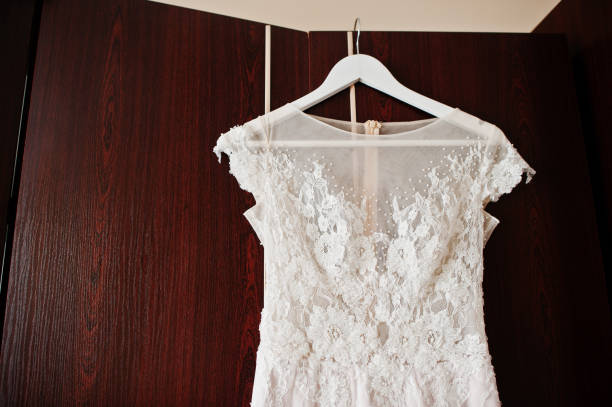 istock White wedding dress on hangers at room. 660742170