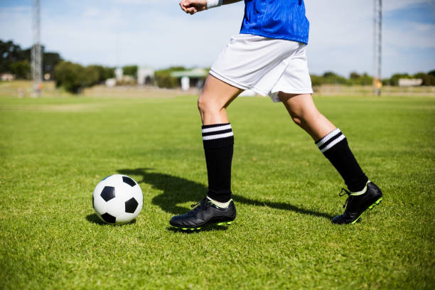 istock Female football player practicing soccer 660751736