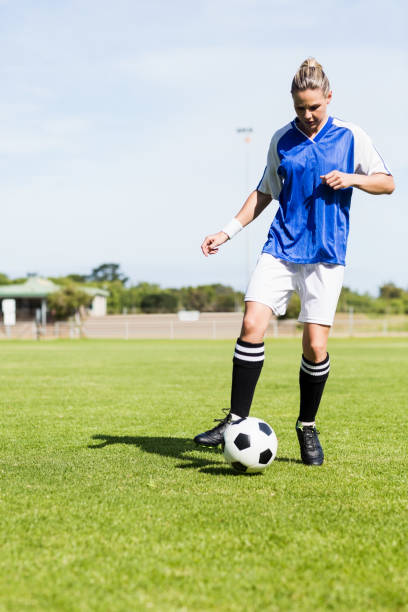istock Female football player practicing soccer 660754128