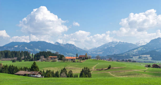 istock Village surrounded by green forests and snow covered mountains 660754594