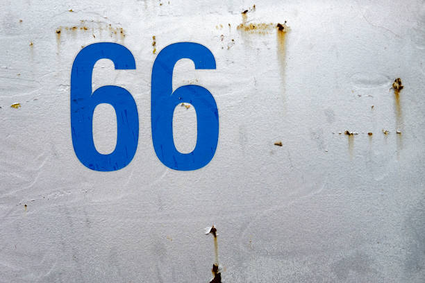 istock Blue number 66 painted on rusty metal wall 660758038