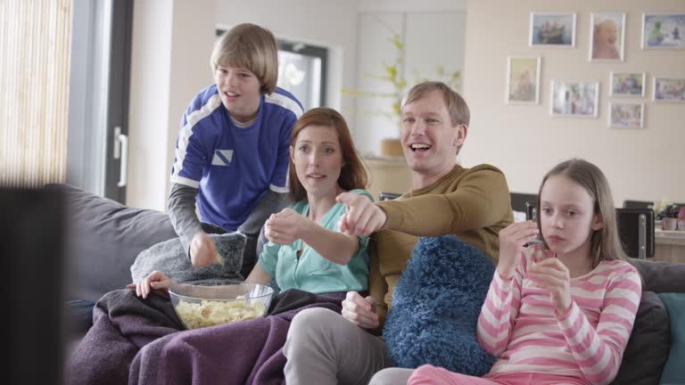 Family cheering watching a football match