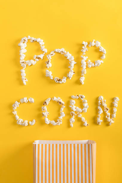 istock Top view of Pop corn lettering  made from popcorn on yellow 660761832