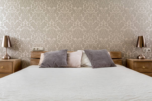 istock Wide bed with wooden bedside cabinets 660764258