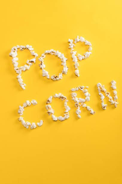 istock Top view of Pop corn lettering  made from popcorn kernels on yellow 660764612