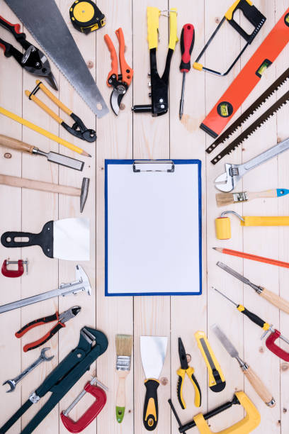 istock Top view of different tools with clipboard on wooden tabletop 660765090