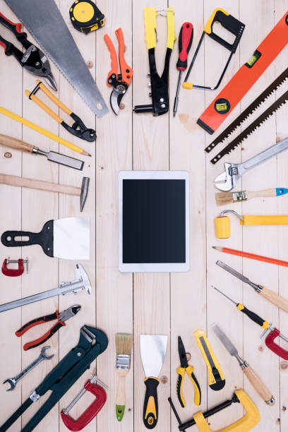 istock Top view of different tools with digital tablet on wooden tabletop 660765564