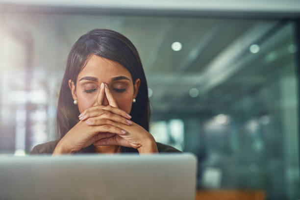 Feeling drained from all her efforts Shot of a young businesswoman looking stressed out while working in an office emotional stress stock pictures, royalty-free photos & images