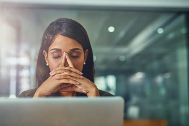 Feeling drained from all her efforts Shot of a young businesswoman looking stressed out while working in an office overworked stock pictures, royalty-free photos & images