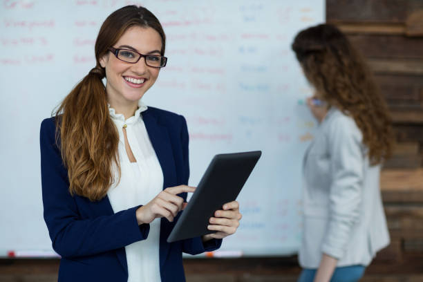 istock Portrait of smiling businesswoman using digital tablet 660772964