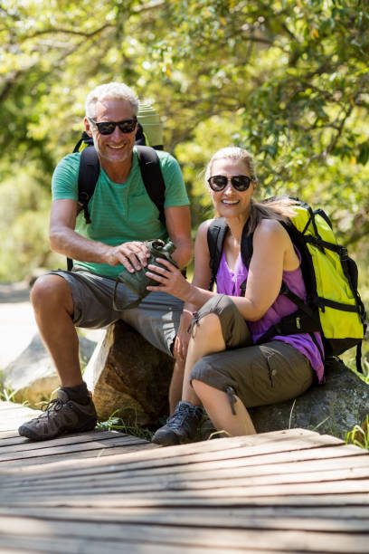 istock Couple smiling and taking a break during a hike 660775764