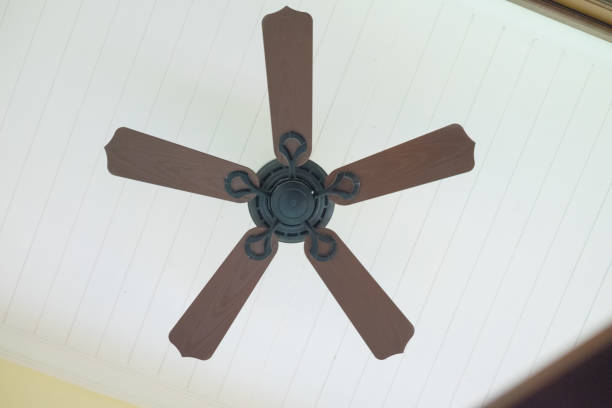istock Five blades brown ceiling fan, interior in house 660775934