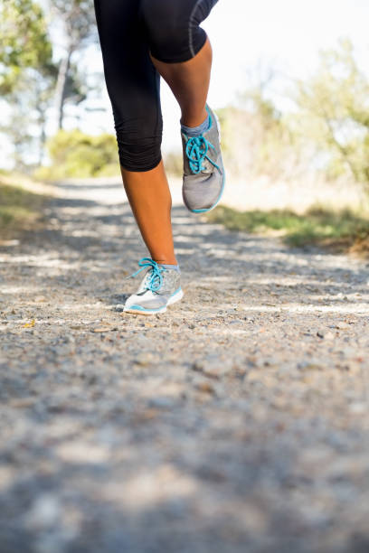 istock Close up woman runners legs running 660776248