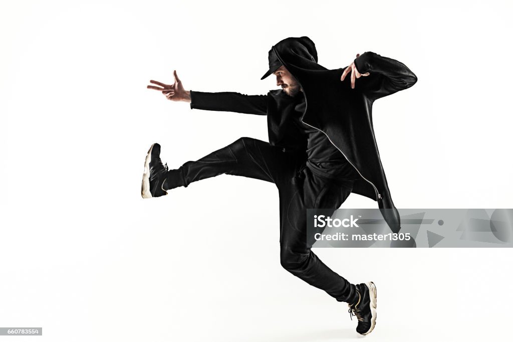 The silhouette of one hip hop male break dancer dancing on white background The silhouette of one young hip hop male break dancer dancing on white background Dancing Stock Photo