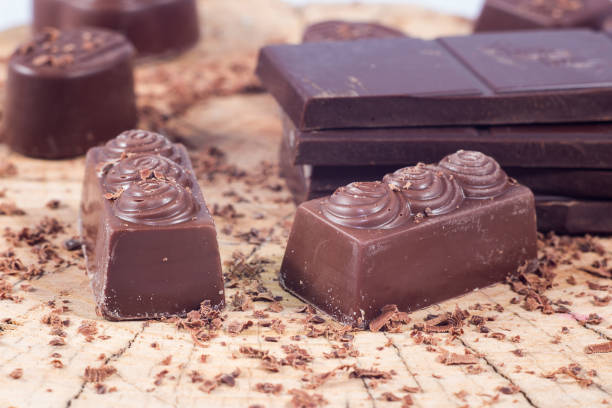 istock Dark chocolate on wooden table. Chocolate crumb 660785056