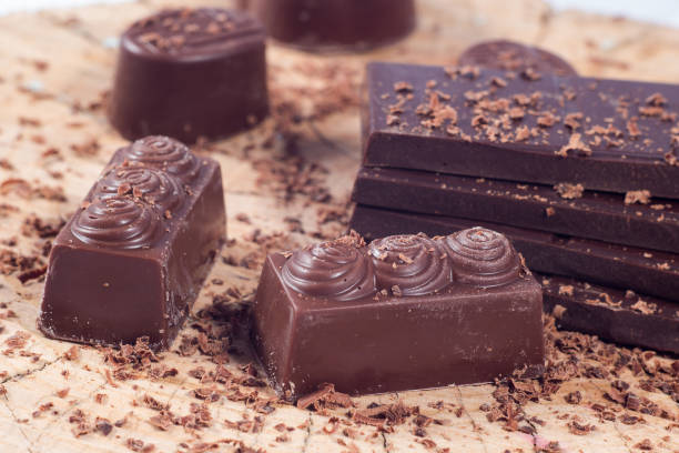 istock Dark chocolate on wooden table. Chocolate crumb 660785086