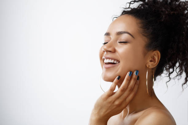 Beauty portrait of happy young woman Beauty portrait of happy young woman with posing against grey background, eyes closed black skin stock pictures, royalty-free photos & images