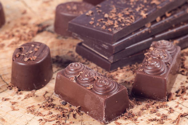istock Dark chocolate on wooden table. Chocolate crumb 660791966