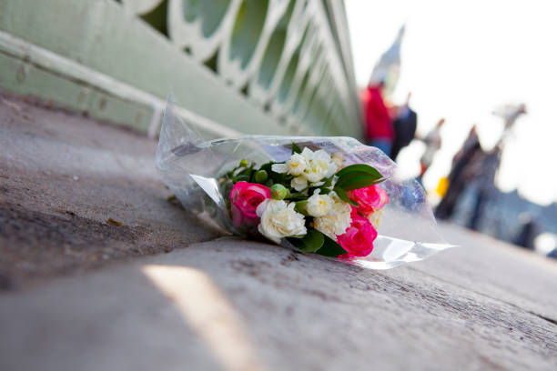 Flowers on London's Westminster bridge  - Day after terrorist attack Flowers in Westminster Bridge the day after the terrorist attack.  terrorist financing stock pictures, royalty-free photos & images
