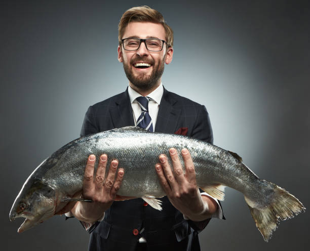 istock A man in a business suit with fresh salmon 660846230