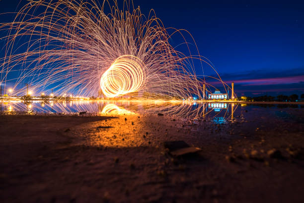 istock swing steel wool fire on mosque of thailand. 660846802
