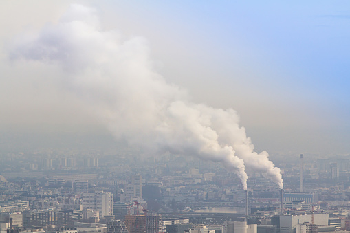 Air pollution by smoke coming out of two factory chimneys, Paris, France